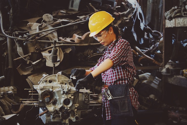 A Female worker is repairing a machine | standard estimation